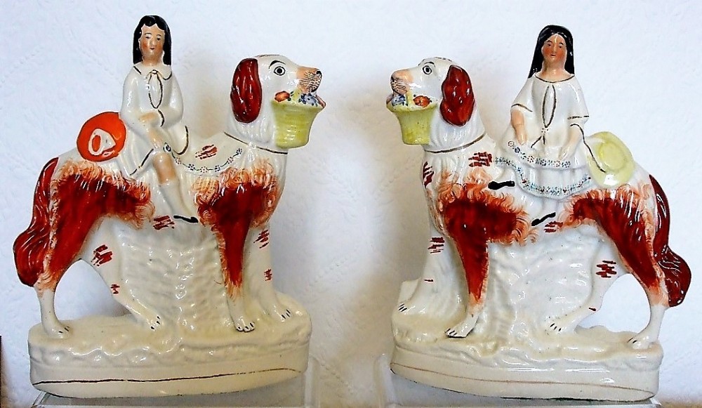 pair of victorian staffordshire figures children on setters